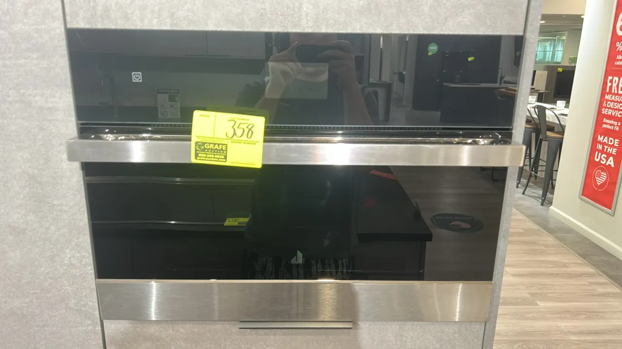2022 Whirlpool JMC2427LM00 built-in household microwave oven. Features drop-down door, black glass front with stainless steel trim, stainless steel in