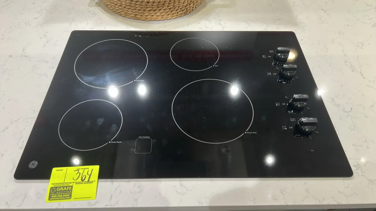 GE JP3030DJ4BB built-in electric cooktop. Features 4 radiant elements, knob controls, Power Boil element, Keep Warm zone, and hot cooktop indicator. 3