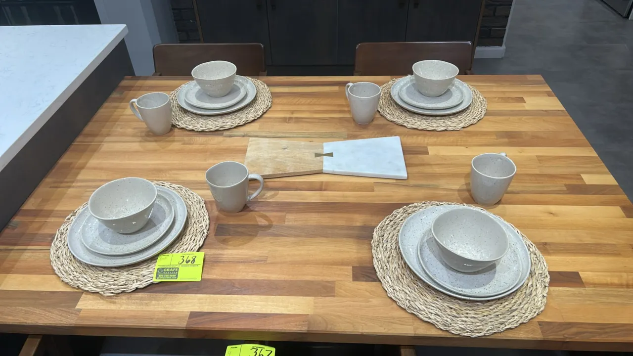 Assorted kitchen smallwares and tabletop decor. Includes ceramic dinnerware place settings with plates, bowls, mugs, and woven placemats; marble and w