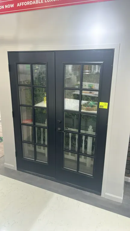 Black double glass panel French patio doors. Features divided-lite glass window inserts and handle hardware. 64"W.