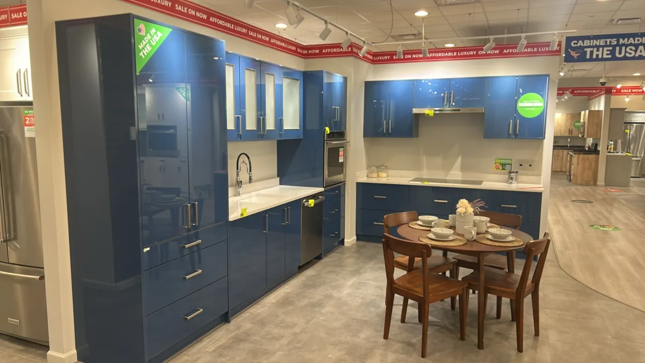 Infinity Plus laminate kitchen cabinets. Features quartz countertops, Blanco undermount sink, stainless steel pull-down faucet, blue gloss finish, fro