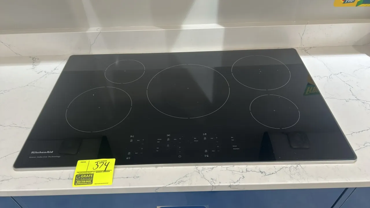 KitchenAid KCIG550JSS00 5-element induction cooktop. Features black ceramic glass surface with stainless steel trim, Sensor Induction Technology, and