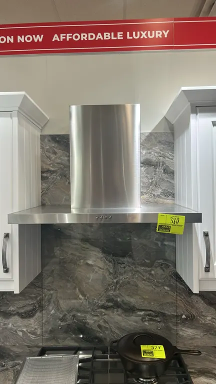 Whirlpool WVW57UC0FS3 stainless steel wall-mount canopy range hood. Features push-button controls, dual underside lighting, mesh grease filters, and c