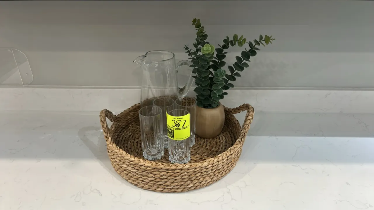 Assorted kitchen smallwares and decor. Includes woven tray, glassware (pitcher, wine glasses, tumblers, storage jars), ceramic dishware (mugs, bowls,