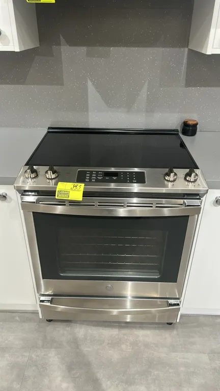 GE Appliances JS760SP4SS 5-burner electric range. Features stainless steel exterior, smooth ceramic cooktop with warming zone, convection oven with tw