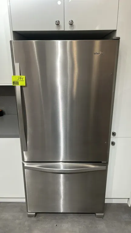 Whirlpool WRB322DMBM03 bottom-freezer refrigerator. Features stainless steel finish, bottom pull-out freezer drawer, adjustable glass shelving, crispe