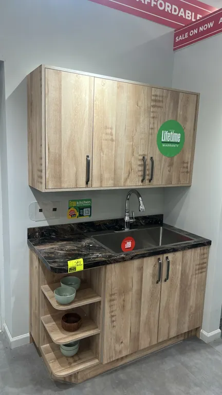 Infinity Plus laminate kitchen cabinets. Features laminate countertops, 55" x 85" section with Blanco stainless steel sink, faucet, upper and base cab