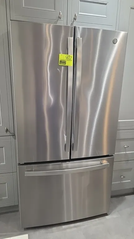 General Electric GNE27JYMTFFS French door refrigerator. Features stainless steel finish, bottom freezer drawer, internal water dispenser, built-in ice