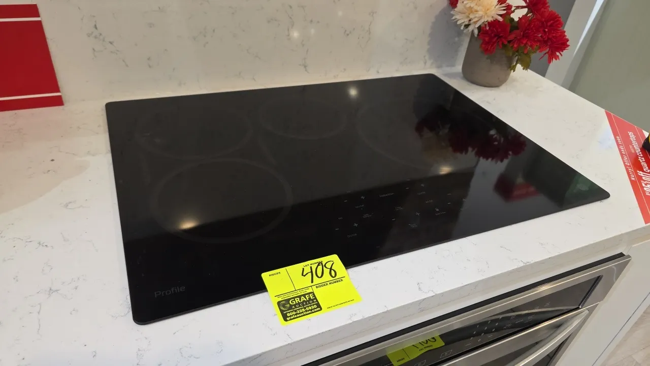 GE Profile PHP9030DJ6BB 30" built-in induction cooktop. Features 4-burner black ceramic glass surface, digital touch controls, burner timer, and sync