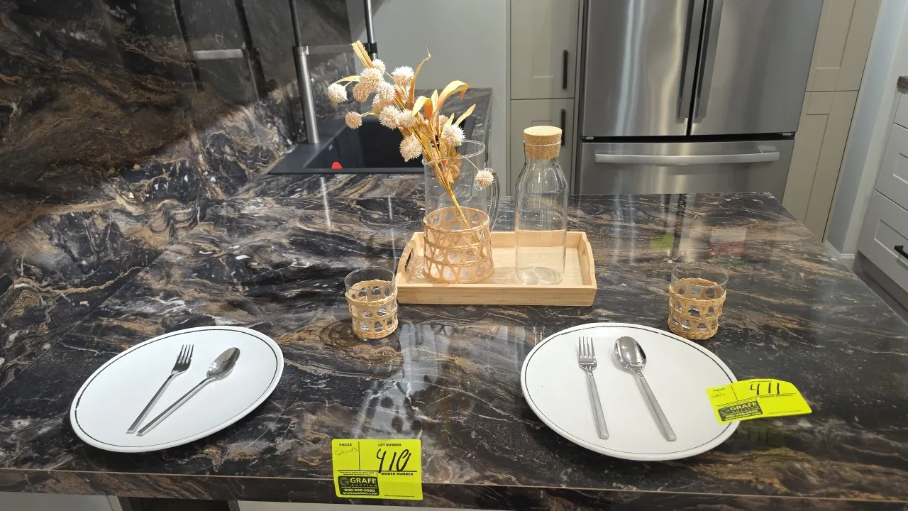 Assorted kitchen smallwares and decorative accessories. Includes dinner plates, flatware, woven-wrapped glasses, glass pitcher with woven sleeve, glas