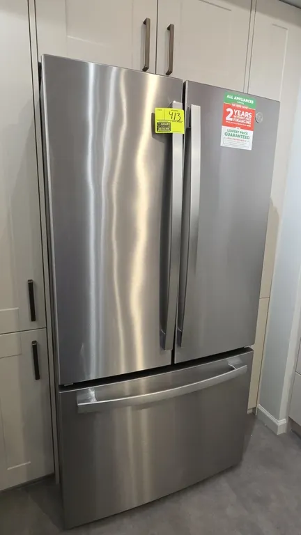 GE GNE27JYMTFFS French door refrigerator. Features stainless steel finish, bottom pull-out freezer drawer, interior water dispenser, built-in ice make