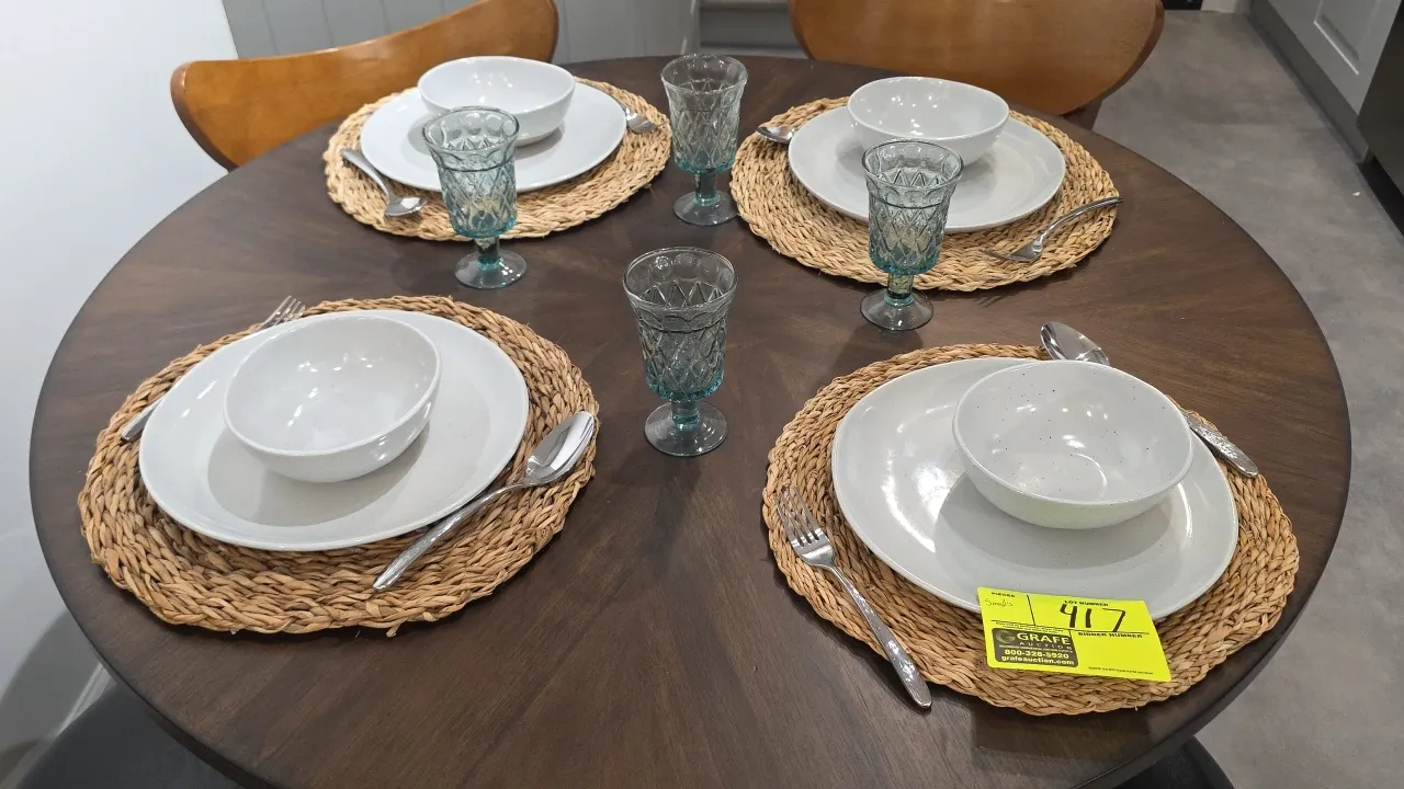 Assorted kitchen and tableware lot. Includes ceramic dinner plates, bowls, mugs, batter bowl, embossed blue glassware and goblets, woven round placema