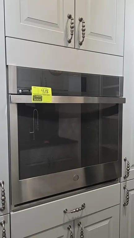 GE Profile PTS7000SN2SS 30" built-in electric wall oven. Features stainless steel construction with glass front door, touchscreen display with Wi-Fi C