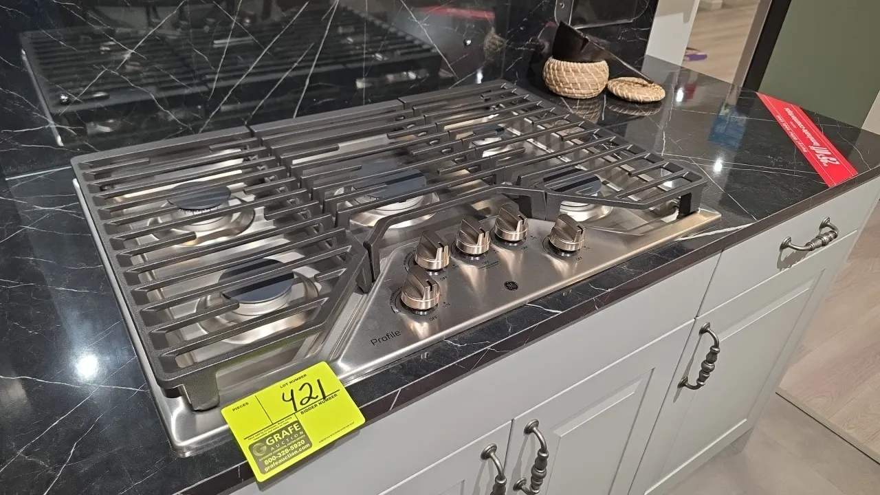 GE Profile PGP7030SL2SS 30" built-in gas cooktop. Features stainless steel finish, 5 burners including central Power Boil burner, continuous cast iron