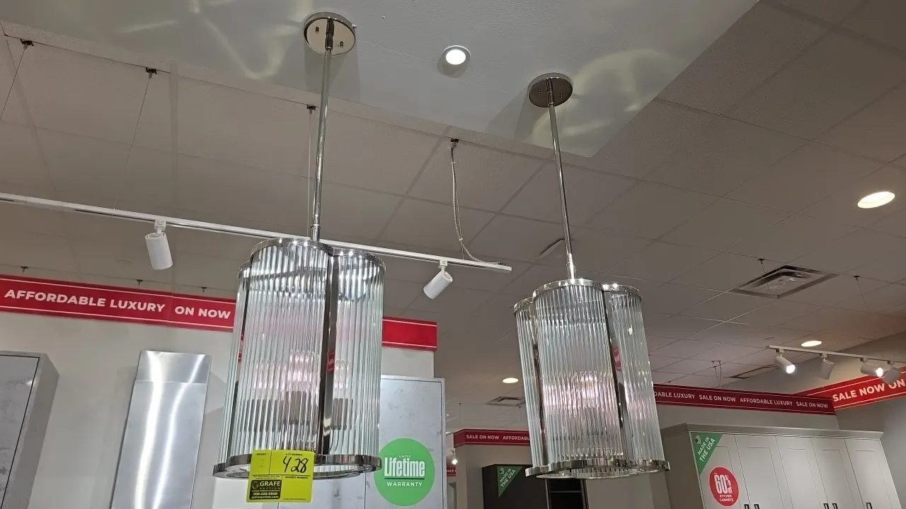 Chrome and glass pendant lights. Features quatrefoil fluted glass shades, polished chrome trim, 4-light cluster, downrods, and ceiling canopies. 12" x