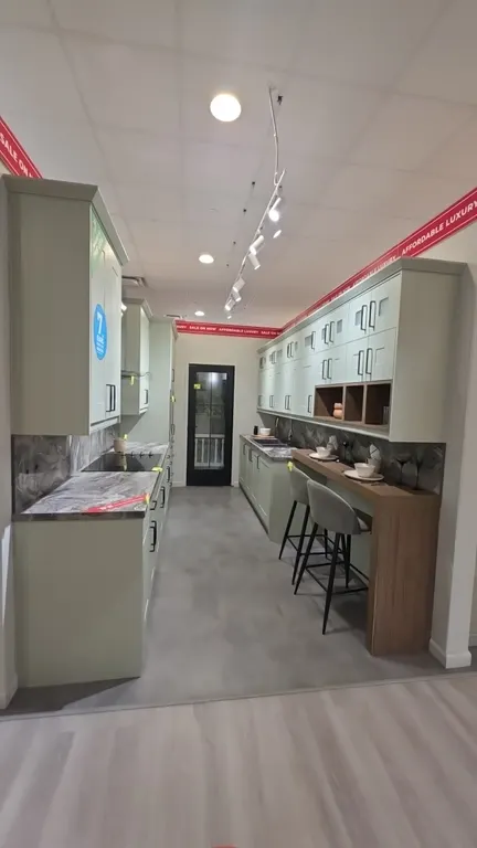 Infinity Plus kitchen cabinet suite. Includes 104" range upper and lower cabinets with laminate countertops and backsplash, 50" x 99"H oven wall cabin