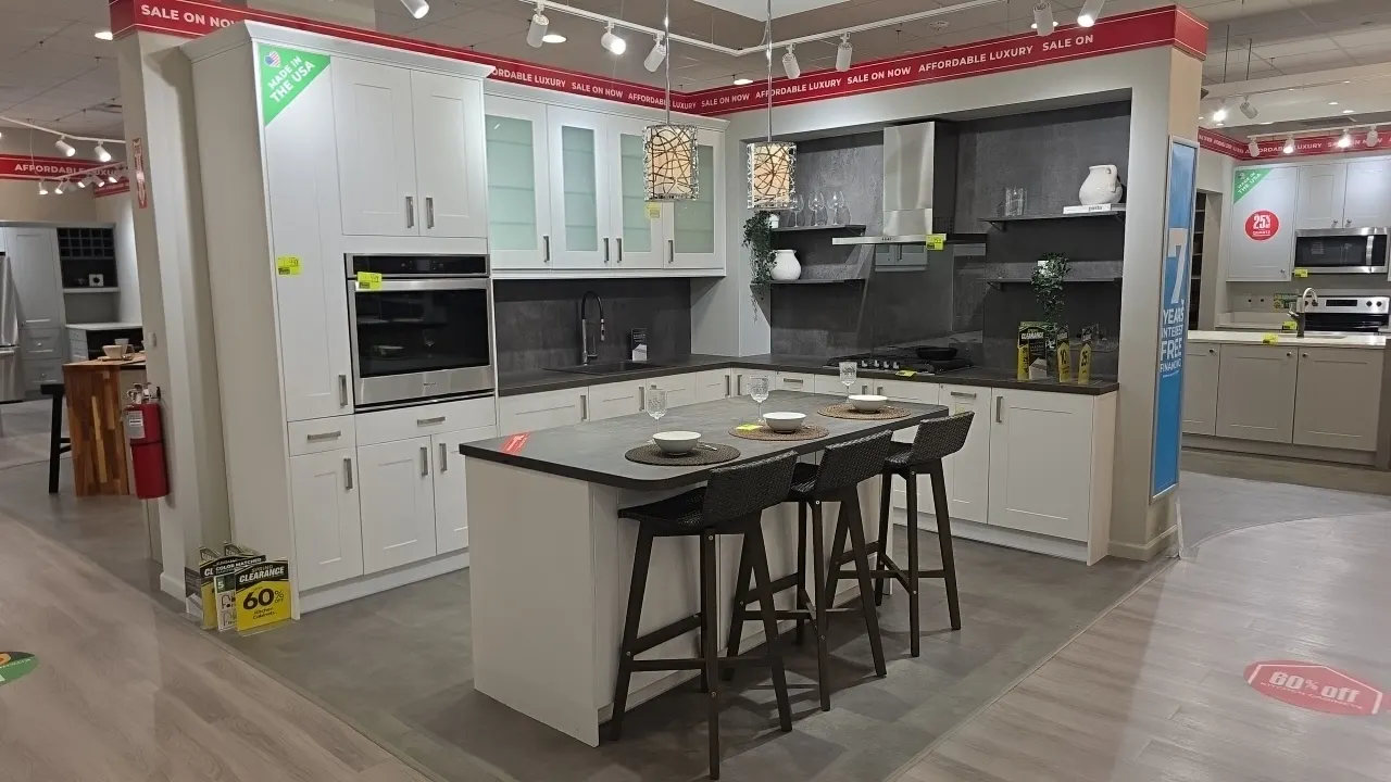 Infinity Plus L-shaped kitchen cabinet set with island. Includes upper and lower cabinets, frosted glass upper doors, laminate countertops, single-bas