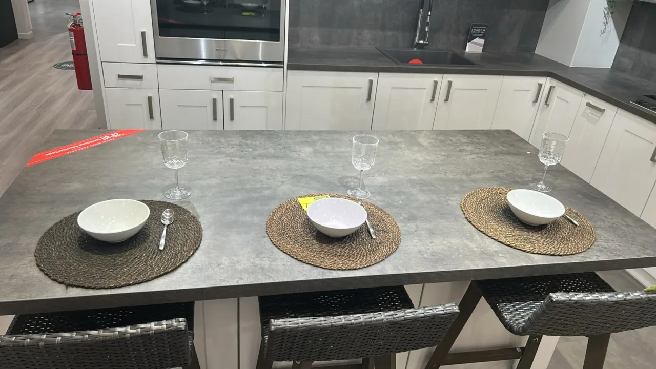 Assorted kitchen and dining smallwares. Includes woven placemats, white ceramic bowls, spoons, assorted glassware and stemware, ceramic pitchers, arti