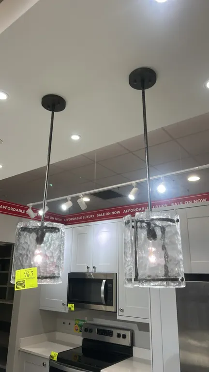 Quoizel Fortress 1-light mini pendants. Features textured ice glass panels, dark metal frame construction, downrods, and matching ceiling canopies. No