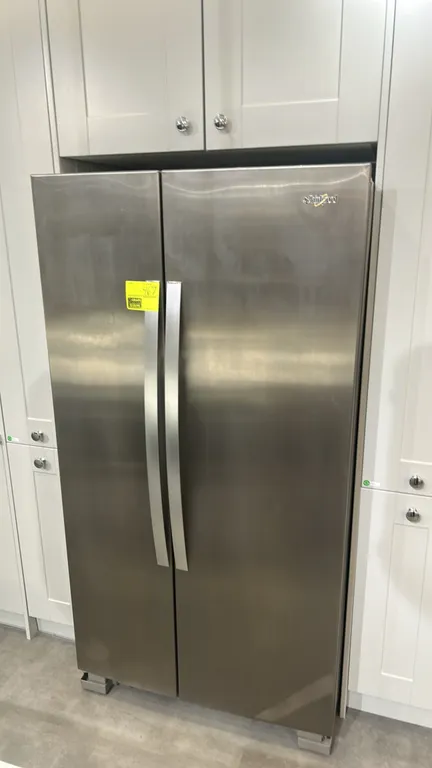 2021 Whirlpool WRS315SNHM06 side-by-side refrigerator and freezer. Features stainless steel finish, glass refrigerator shelving, crisper drawers, wire