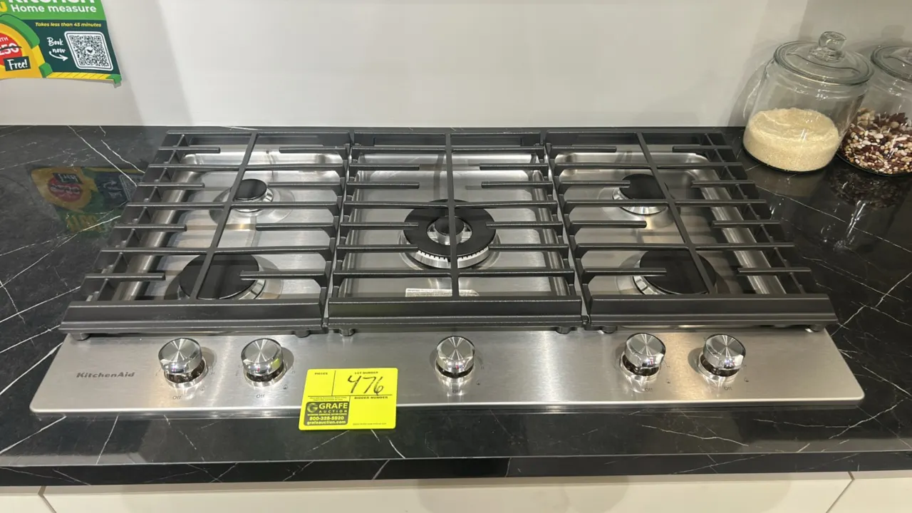 KitchenAid KCGS556ESS 5-burner gas cooktop. Features stainless steel finish, continuous cast iron grates, and front-mounted control knobs. 36"W. Count