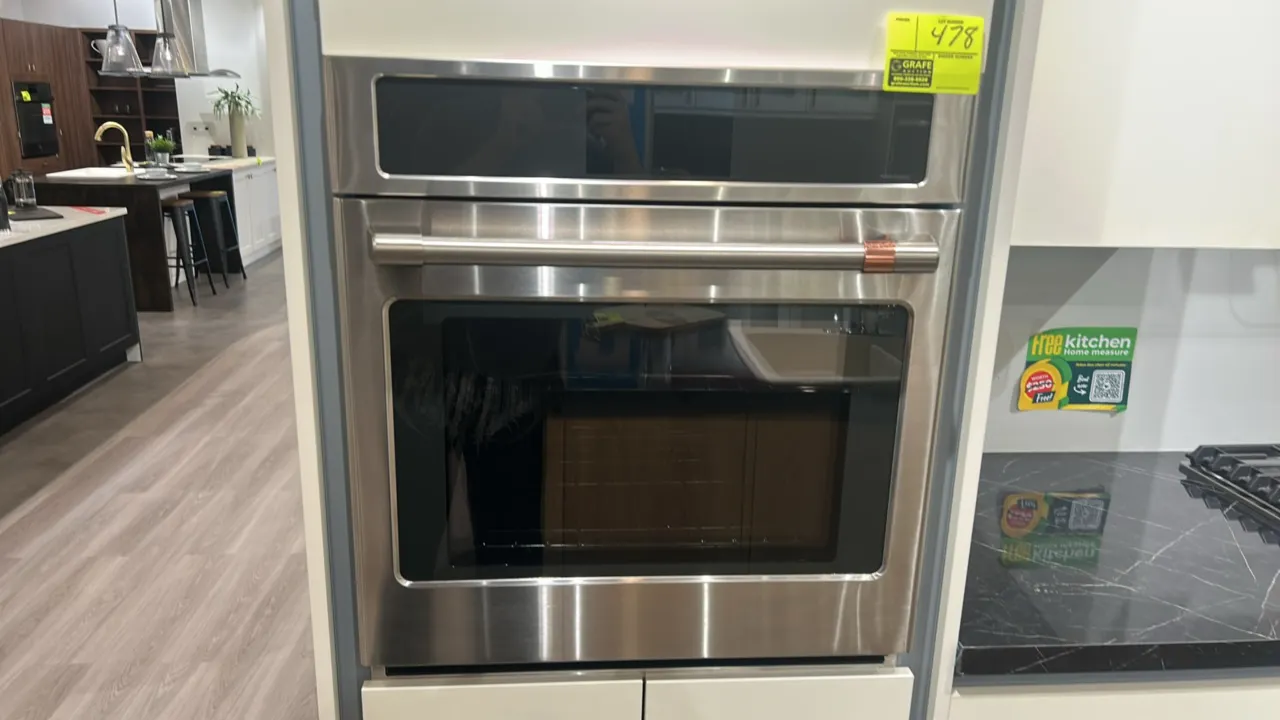 Café CKS70DP2N2S1 smart single convection wall oven. Features stainless steel finish with copper accent handle, glass door, digital touch display, int