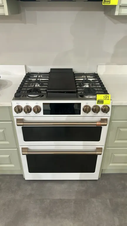 Café CGS750P4M3W2 smart slide-in gas double-oven range. Features 6 gas burners with integrated cast iron griddle, convection oven, matte white finish,