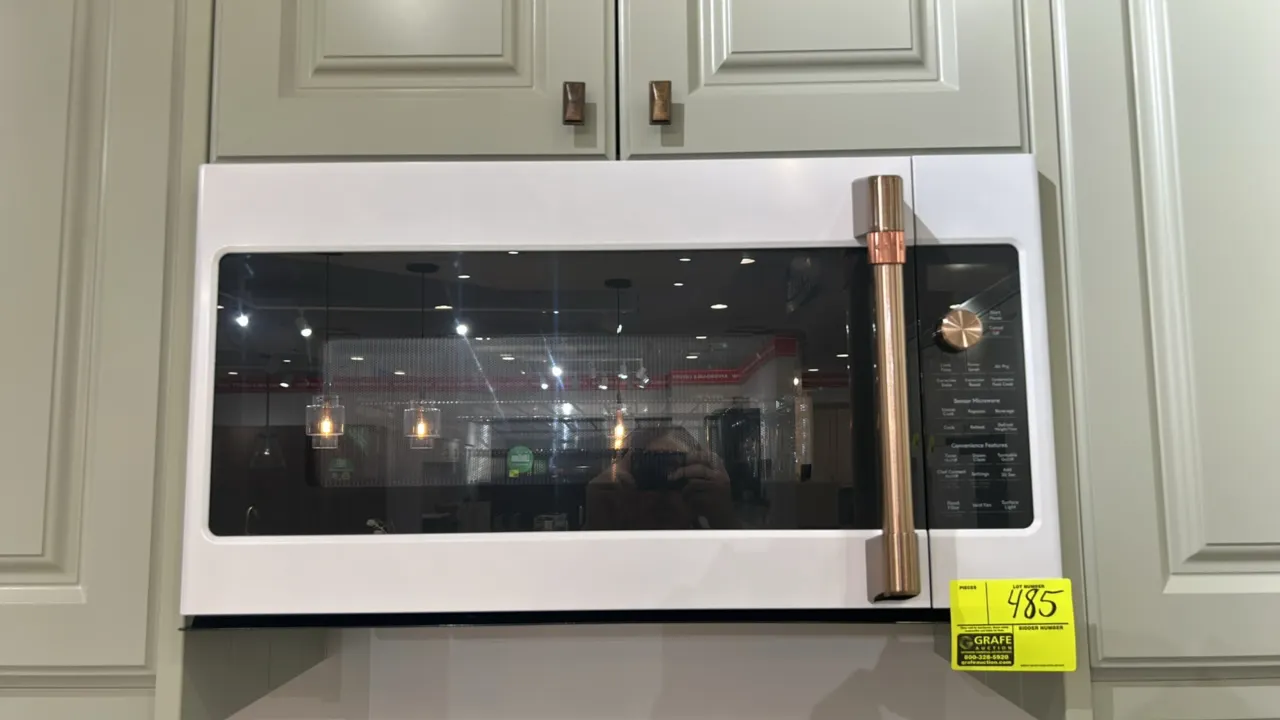 2022 Café CVM517P4R1W2 convection over-the-range microwave oven. Features matte white finish, brushed bronze handle and dial, stainless steel interior