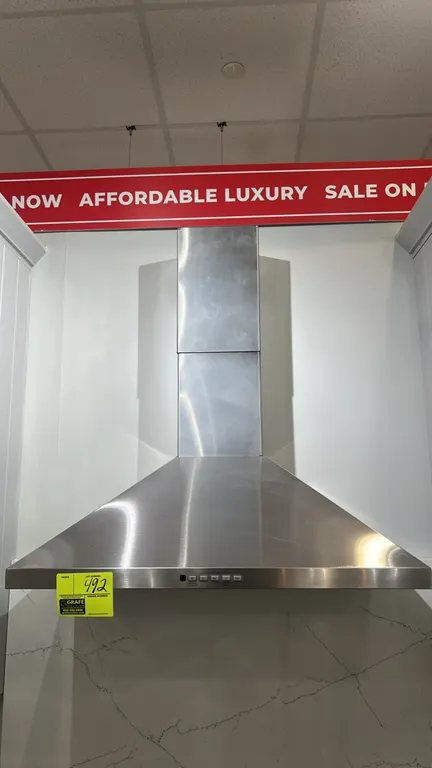 GE JVW5301SJ1SS convertible wall-mount range hood. Features stainless steel finish with chimney flue, push-button controls, and integrated lighting. 3