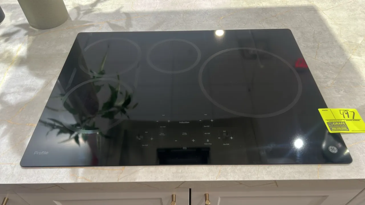 GE Profile PHP9030DJ6BB built-in 4-burner induction cooktop. Features black ceramic glass surface, digital touch controls, sync burner capability, tim