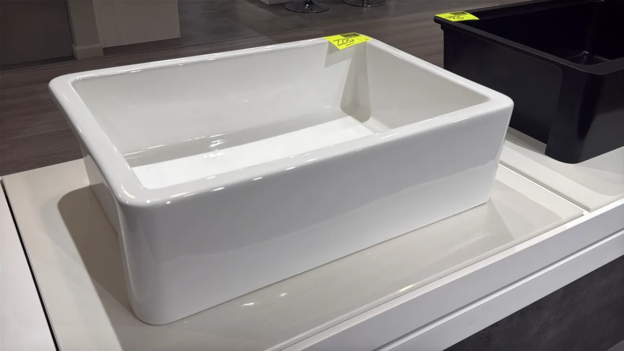 Iris SI.WRN.US.009 ceramic farmhouse apron-front sink. Features a single-bowl basin design with a glossy white finish and a center drain opening. 30"W