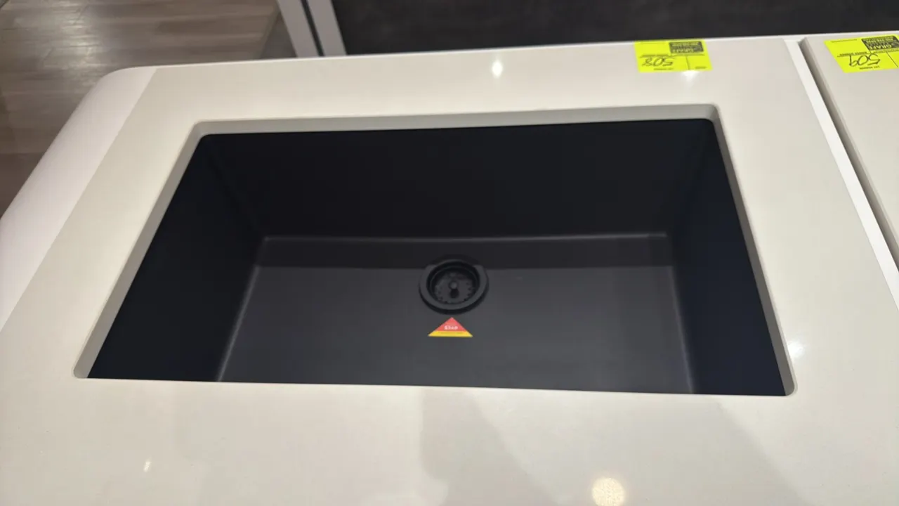 33" single-bowl composite kitchen sink. Features dual-mount design, matte black finish, and center drain assembly. 33"W. Countertop not included.