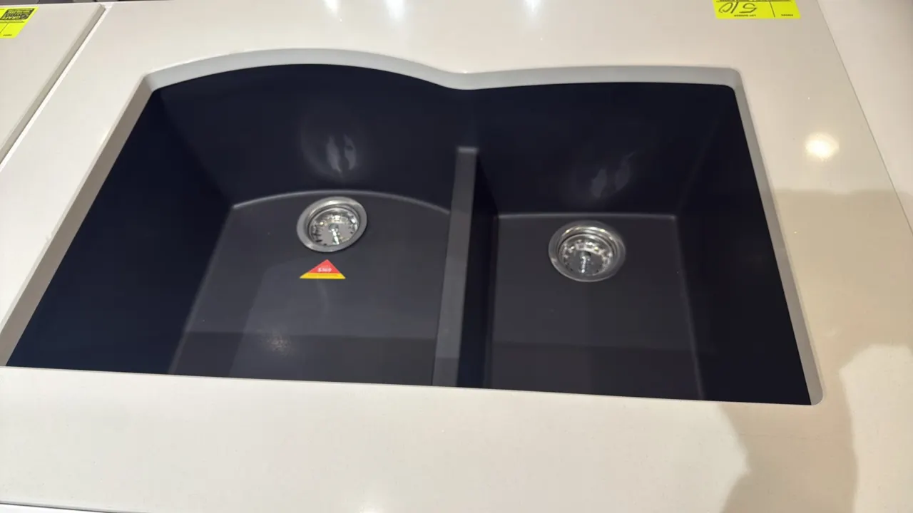 33" 2-bowl composite dual-mount kitchen sink. Features a 60/40 split basin configuration and matte black finish. Includes stainless steel strainer ass