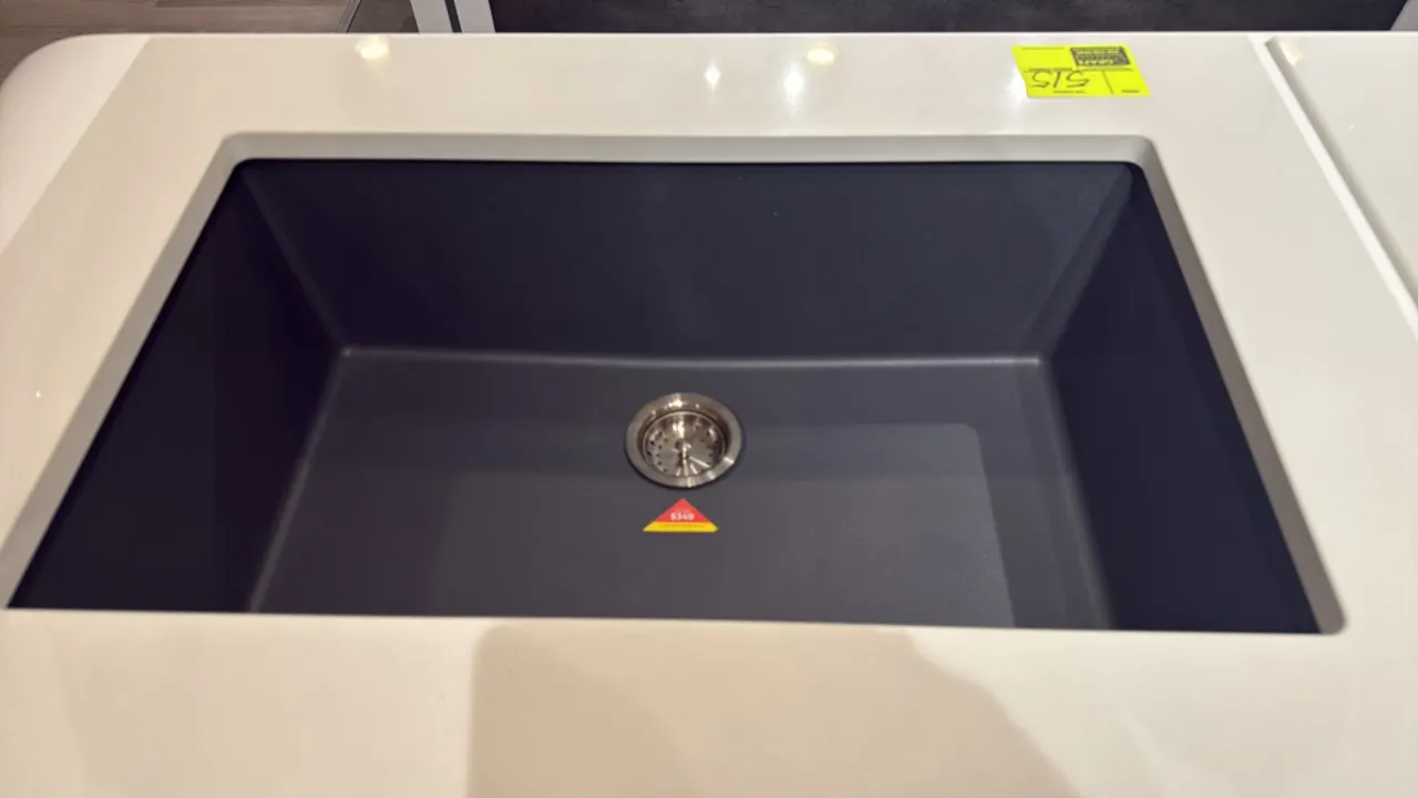 33" single-bowl composite kitchen sink in concrete gray. Features dual-mount installation design and center drain with stainless steel basket strainer