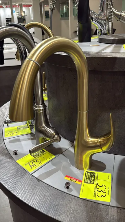 Bocchi Yukon pull-down kitchen faucet. Features a single-handle lever design, high-arc spout with pull-down spray head, and brushed gold finish. Note: