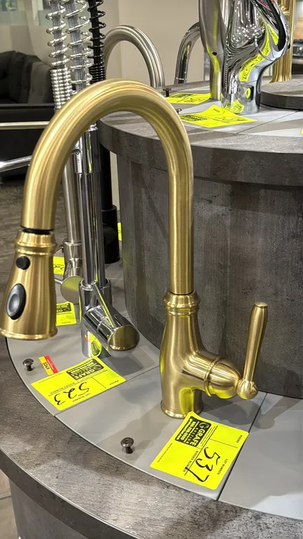 Bocchi pull-down kitchen faucet. Features a brushed gold finish, single-lever handle, high-arc spout, and pull-down spray head with push-button contro