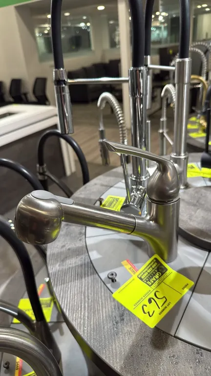 Yenisei pull-down kitchen faucet. Features brushed nickel finish, single-lever handle, and pull-down spray wand. Display carousel and background fauce