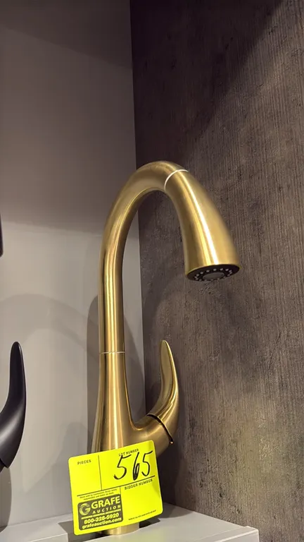 Yukon pull-down faucet. Features a brushed gold finish, single-lever control handle, and pull-down spray head.