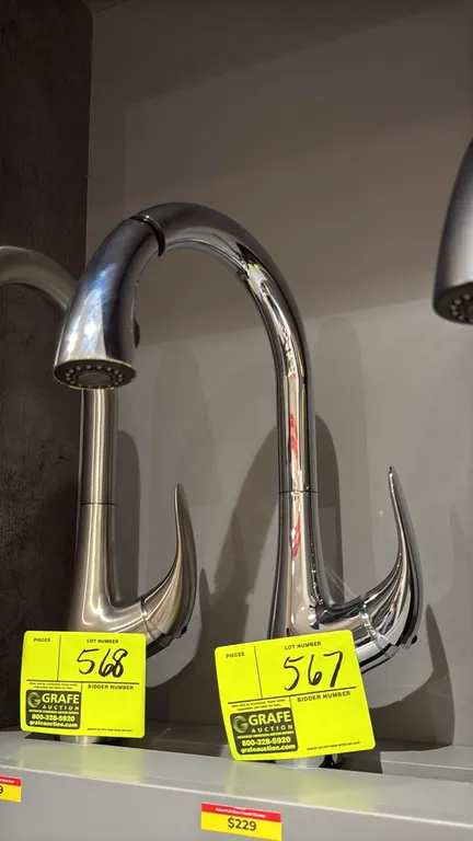 Yukon pull-down faucet. Features a polished chrome finish, high-arc gooseneck spout, pull-down spray head, and single-lever handle design. Deck mounte