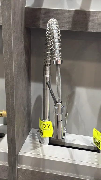 Chrome pull-down spring kitchen faucet. Features high-arc open coil spring spout, single-handle lever control, and pull-down spray head. Display stand
