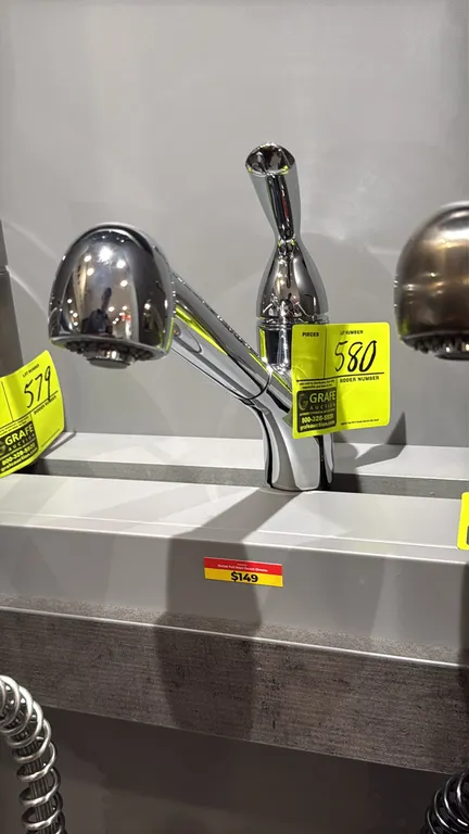 Yenisei single-handle pull-down faucet. Features a polished chrome finish, single lever handle, and pull-down spray wand. Display stand not included.