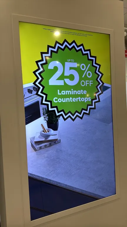 Sony 75" LCD display monitor. Features digital signage display configured in portrait orientation. 75" diagonal screen size. Architectural column and