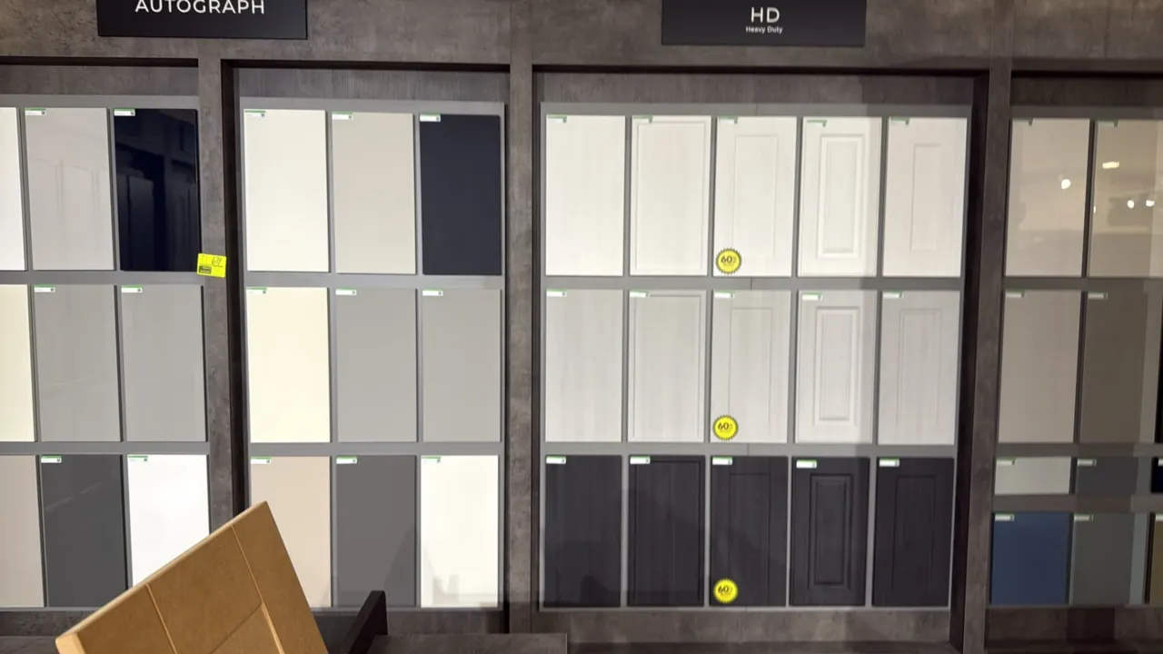 Wren cabinet style display sections. Features display panels mounted with assorted cabinet door style and color finish samples, including Autograph, H