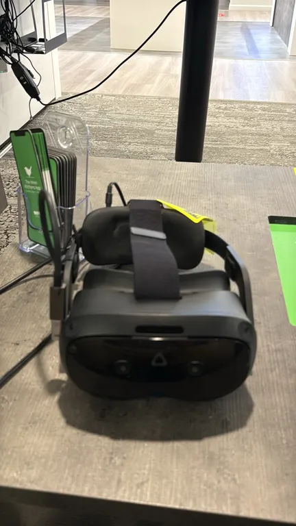 HTC VIVE Focus Vision virtual reality headset. Features integrated front tracking cameras, adjustable head strap with rear adjustment dial, padded fac