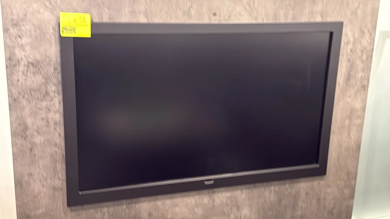 Samsung 50" flat screen color display monitor. Features a black bezel frame. Wall-mounted.