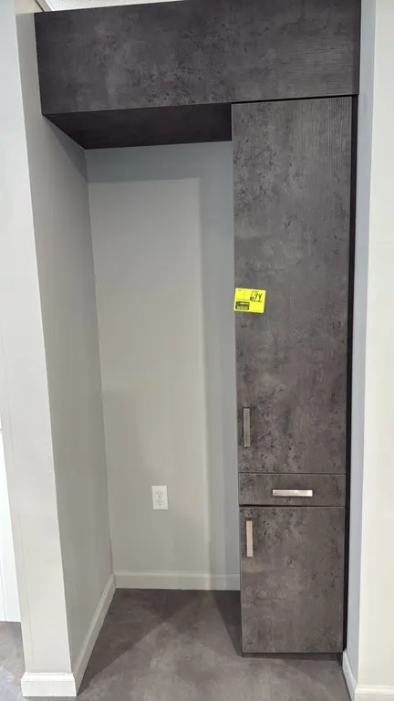 Laminate storage cabinet. Features a dark gray textured finish, upper cabinet, center drawer, lower cabinet, and matching top header panel. 15.5" x 80