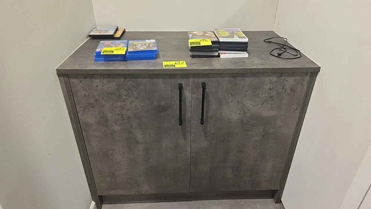 Laminate 2-door storage cabinets. Features double doors with black bar handles, interior shelving with center divider, and gray textured laminate fini