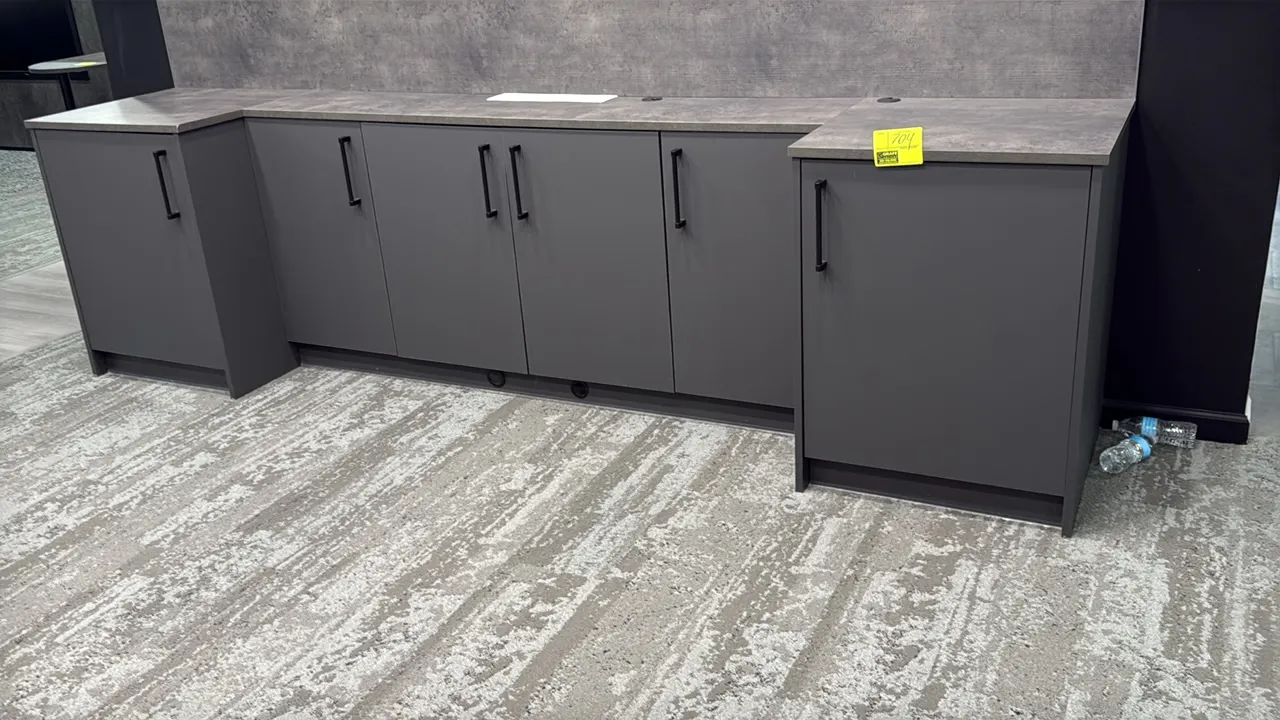 Modular base cabinets with countertop. Features charcoal gray finish, (6) hinged cabinet doors with black bar pulls, stepped design with recessed cent