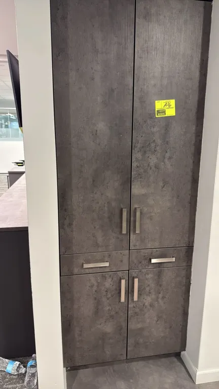 Laminate storage cabinet. Features a textured dark gray laminate finish, upper double doors, two center drawers, lower double doors, and brushed metal