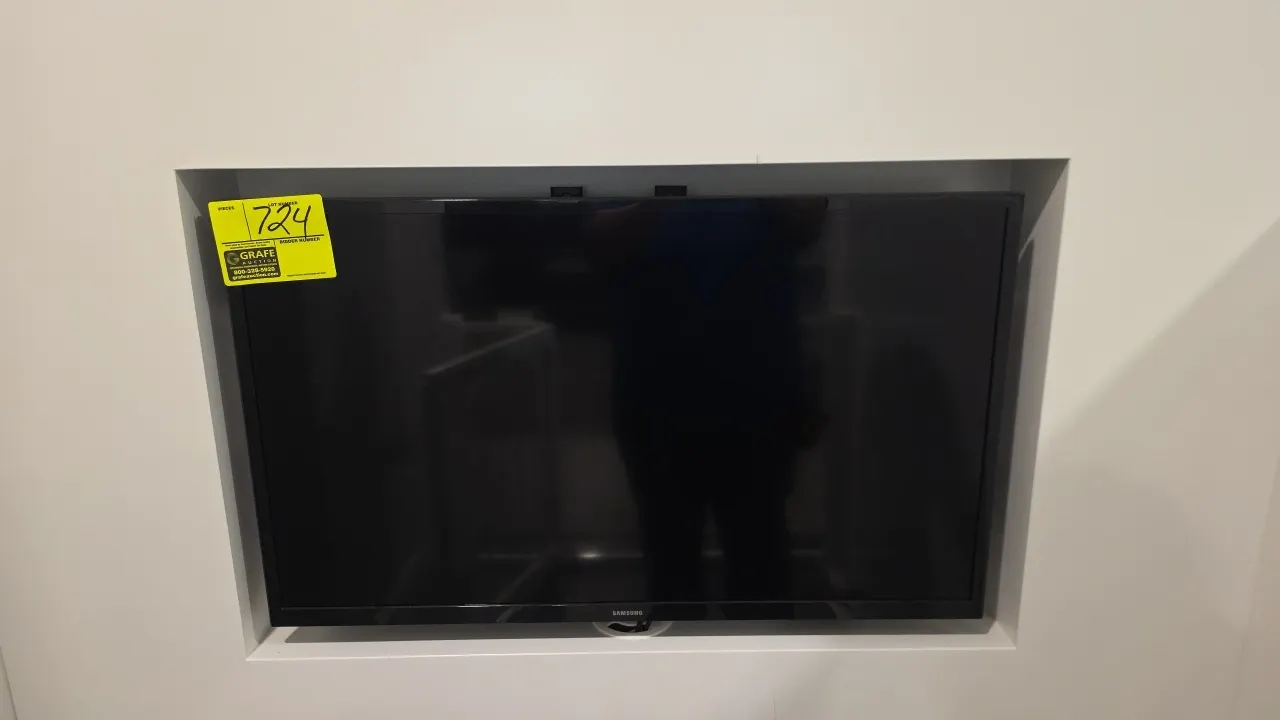 Samsung 32" flat screen TV. Features a black frame. Wall-mounted.